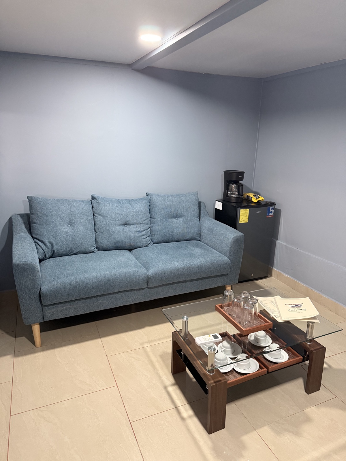 Sofa, coffee table and coffee machine in the VIP lounge